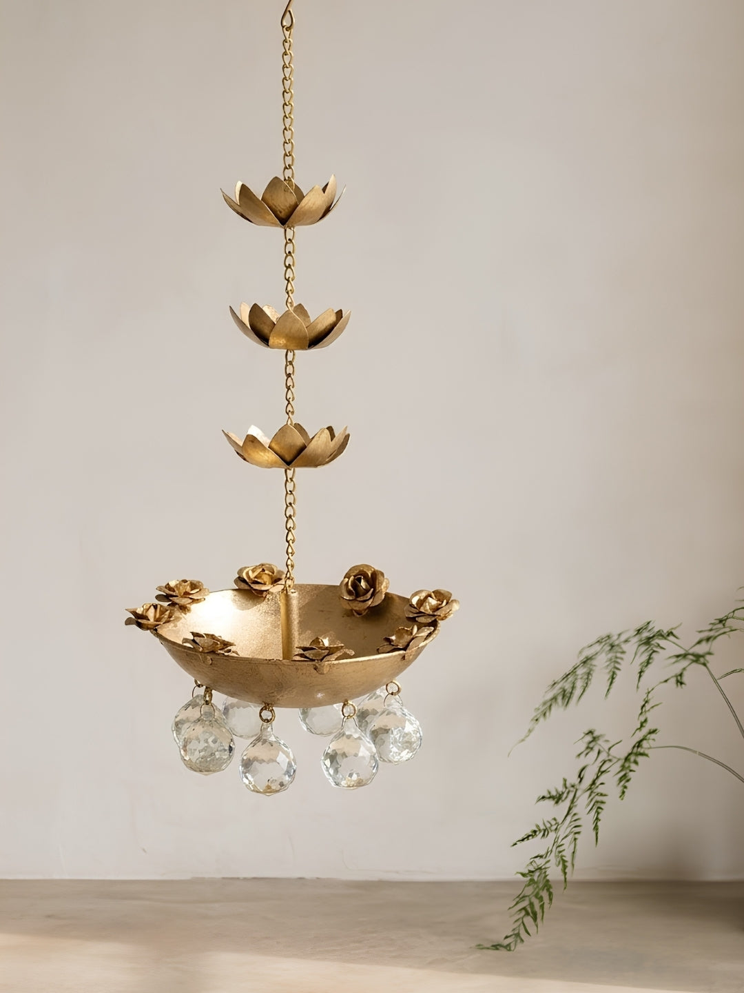 Metal gold finish hanging urli with crystal drops