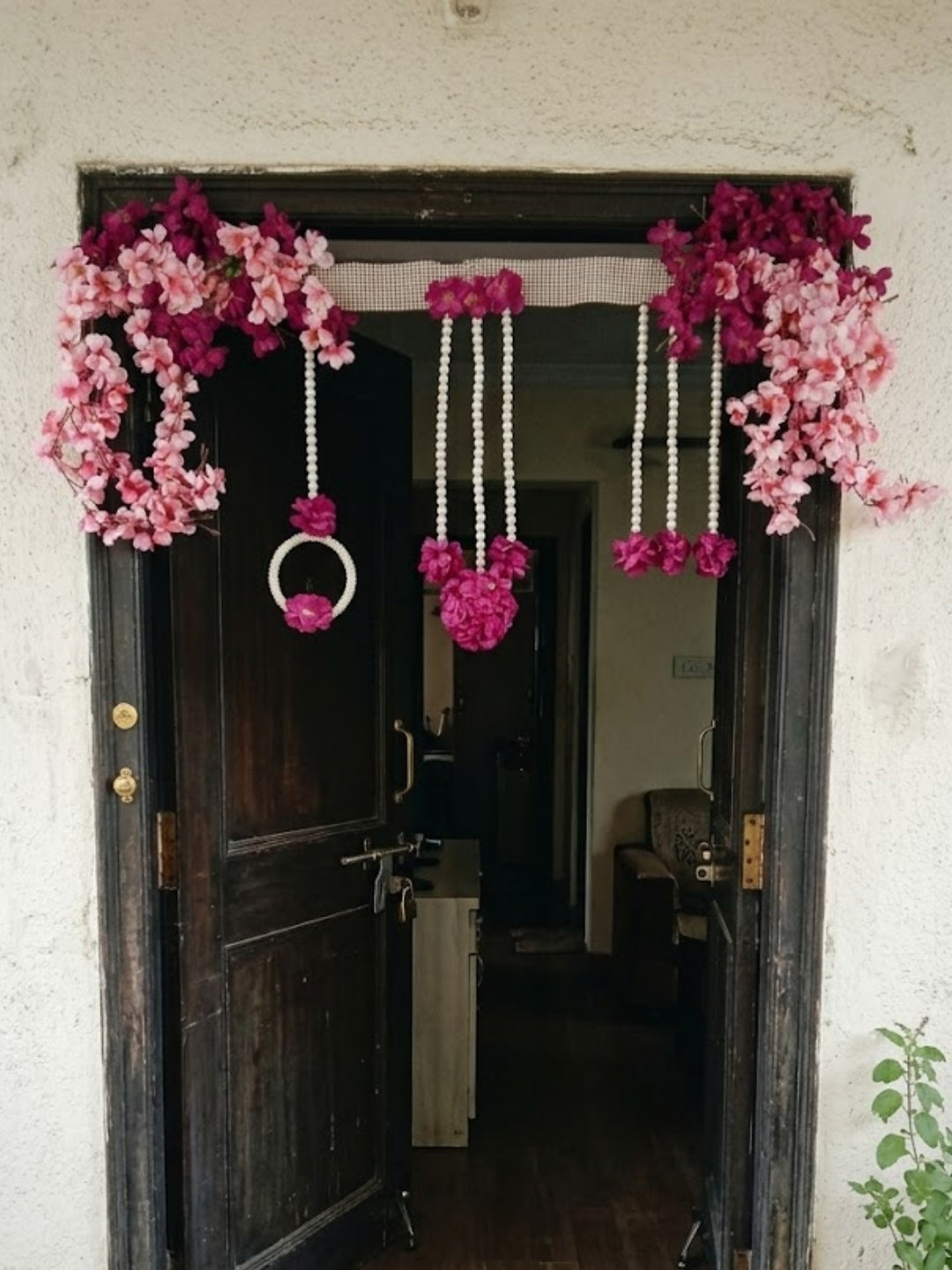 Artificial pink & purple flower with moti ring toran